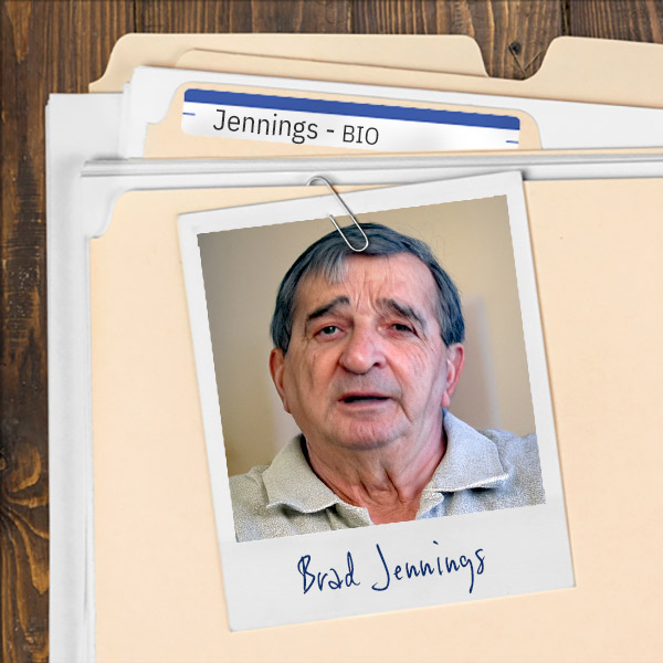 A file folder with a photo of an older man with dark, graying hair