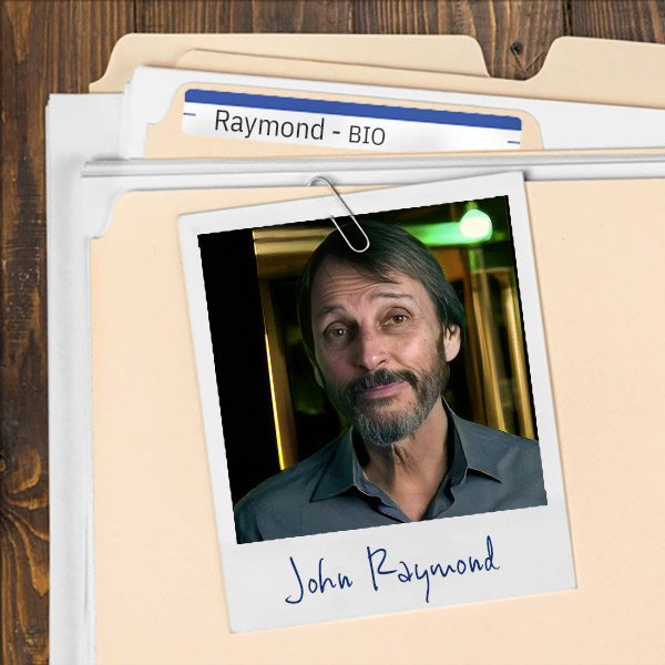 A file folder with a photo of a slightly smiling man with dark hair, moustache, and beard.