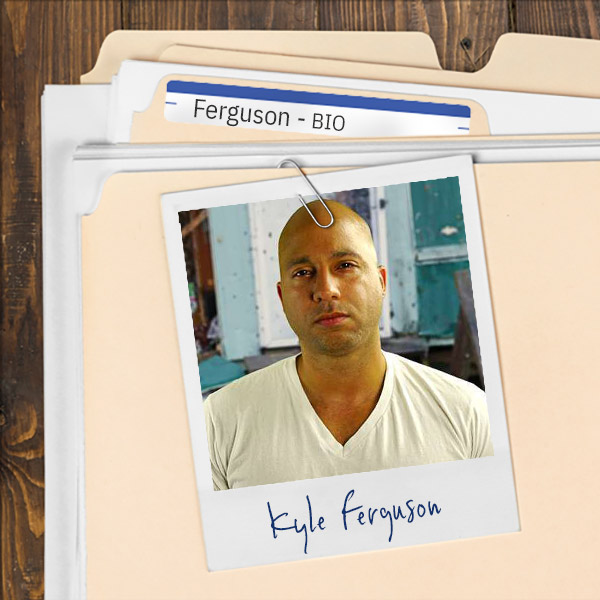 A file folder with a photo of a muscular man with a shaved head.