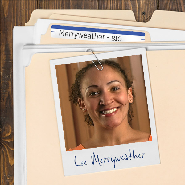 A file folder with a photo of a smiling woman with curly hair pulled back.