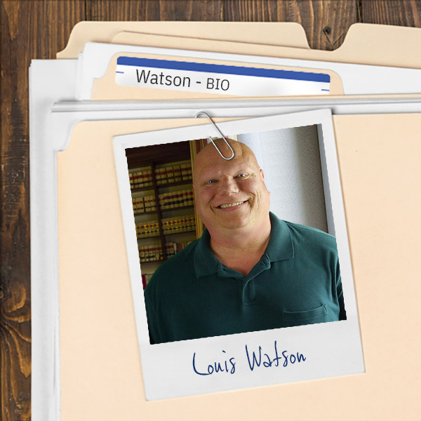 A file folder with a photo of a smiling bald man in a law library.