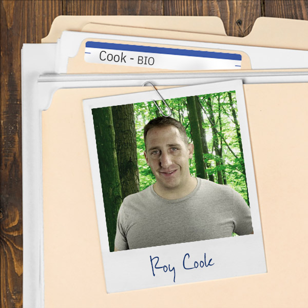 A file folder with a photo of a smiling man with short brown hair.