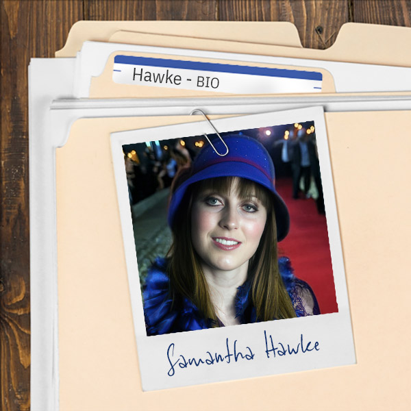 A file folder with a photo of a A file folder with a photo of a smiling brunette woman in a blue hat.