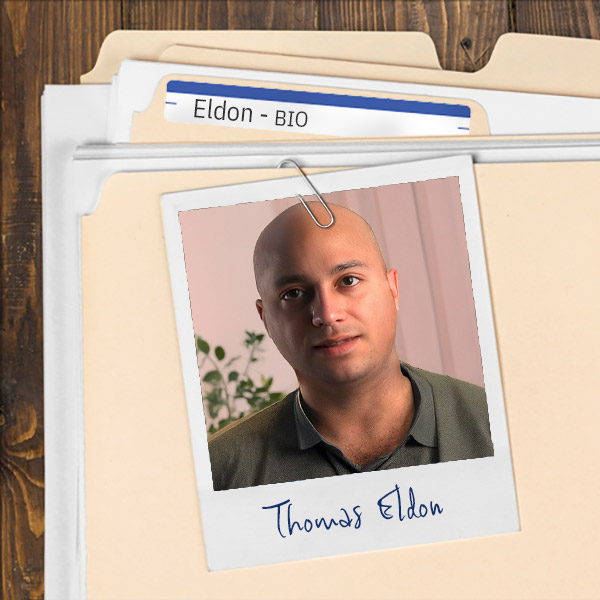 A file folder with a photo of a Serious-looking bald man.