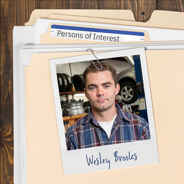 A file folder with a photo of a young man with dark hair and eyebrows.