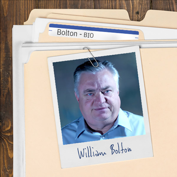 A file folder with a photo of a unhappy-looking man with short salt-and-pepper hair.
