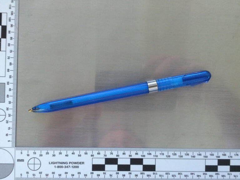 a picture of a blue ballpoint pen taken near a 90-degree measuring ruler