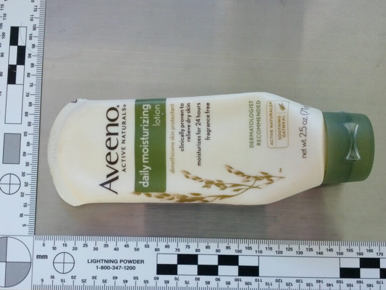 a picture of a lotion bottle taken near a 90-degree ruler.
