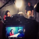 a picture of a digital camera capturing a group of directors and actors working