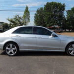 A picture of a silver-colored car with 4 doors
