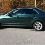 A picture of a gasoline green colored car.