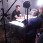 A picture of a group of directors and actors sitting around a table.