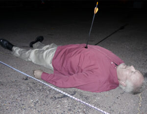 a picture of a side shot of a dead body with an arrow struck in its chest.