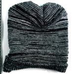 A picture of a grey and black hat with many stripes.