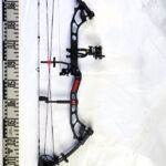 a picture of a compound heavy bow weapon taken near a 90-degree measuring ruler.