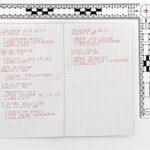 A picture of a notebook coded in an unknown language using symbols.