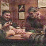 an old looking picture of 4 men sitting around a table playing poker and drinking alcohol.