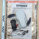 A picture of a disassembled drone in an evidence bag.