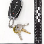 A picture of a key chain with 4 keys attached to it.