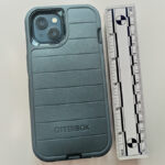A picture of an Iphone taken near a measuring ruler