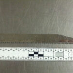 A picture of a knife blade set next to a 90-degree measuring ruler