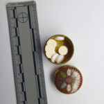A picture of a circular pillbox with pills inside
