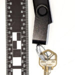 A picture of a Ross usb keychain near a measuring ruler.