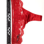 A picture of a red thong taken near a 90-degree measuring ruler.