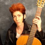 a picture of a person with a guitar and a dark background