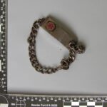 a picture of a dirty bracelet taken near a measuring ruler