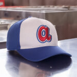A picture of a bue and white hat with the letter "a" on it