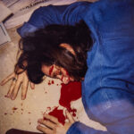 A picture of a body with blood pooling from under the head.