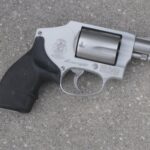 A picture of a revolver on the floor.