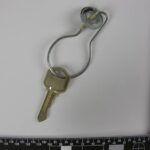 a picture of a keyring taken near a measuring ruler