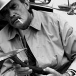 A picture of a man taken holding a tool