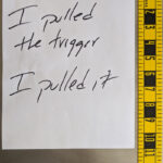 a picture of a small note taken near a measuring ruler.