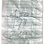 A picture of a note written on a bill telling a time