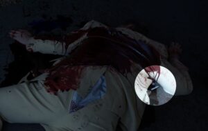 Person in beige or yellow colored suit lying prone. Rip in pants exposing underwear. Close up image exposed of a paper.