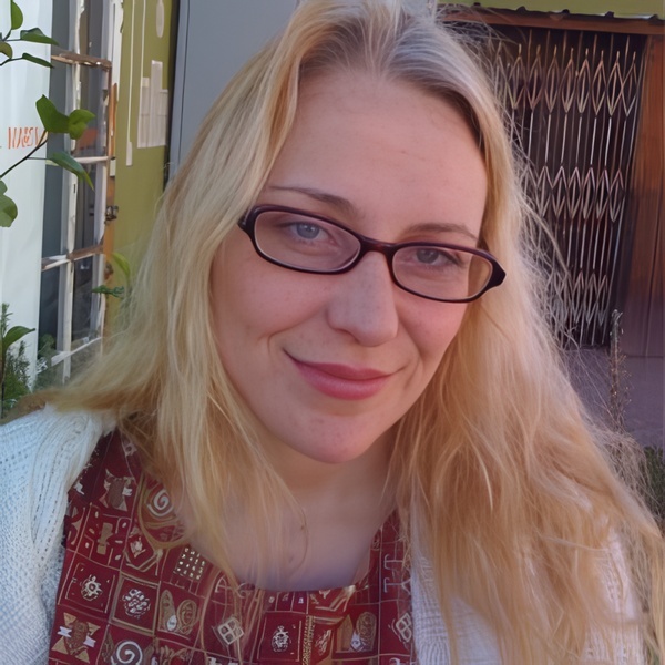 Smiling woman with long blonde hair and glasses