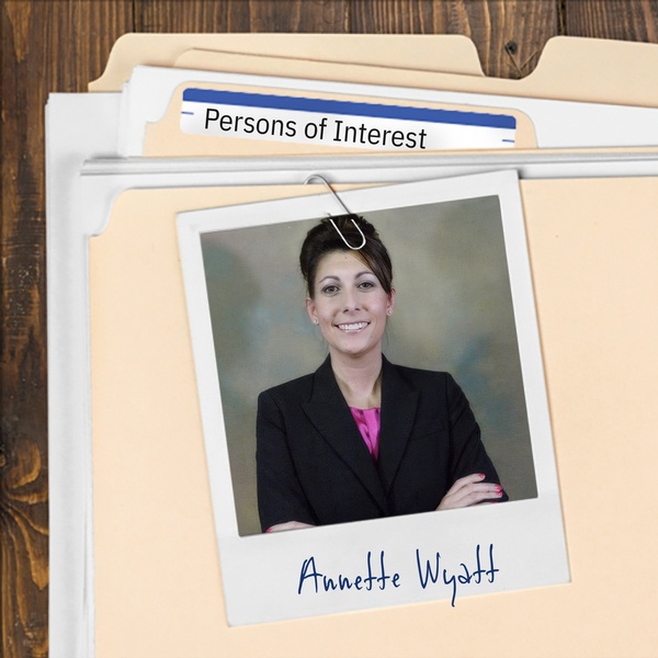 Manila folder with a photo of a smiling businesswoman with arms folded clipped to it