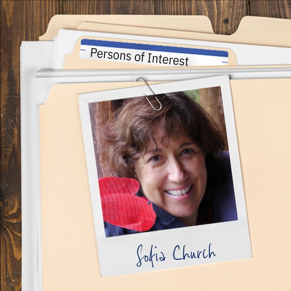 Manila folder with a photo of a smiling woman with short dark hair clipped to it