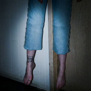 A woman's feet and legs suspended above the floor