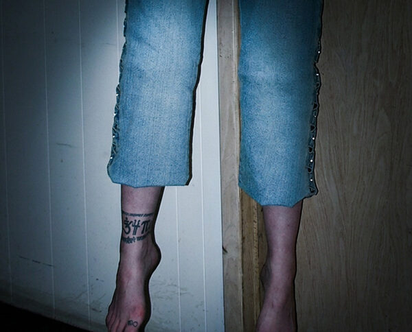 A woman's feet and legs suspended above the floor