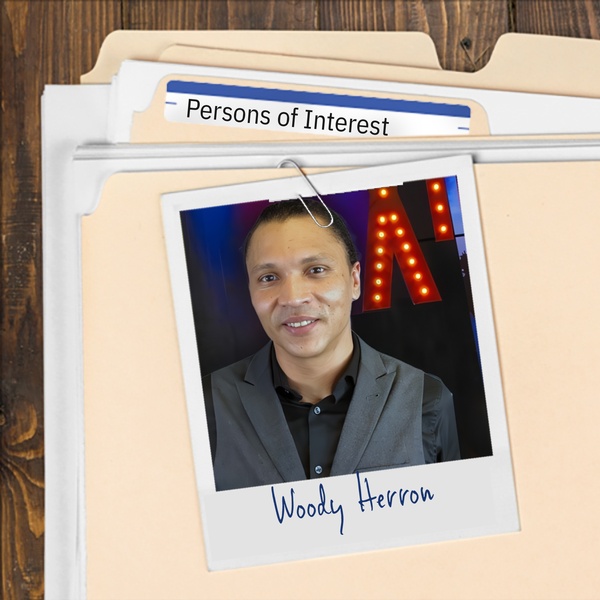 Manila folder with a photo of a slightly smiling man with cornrows and a light mustache clipped to it