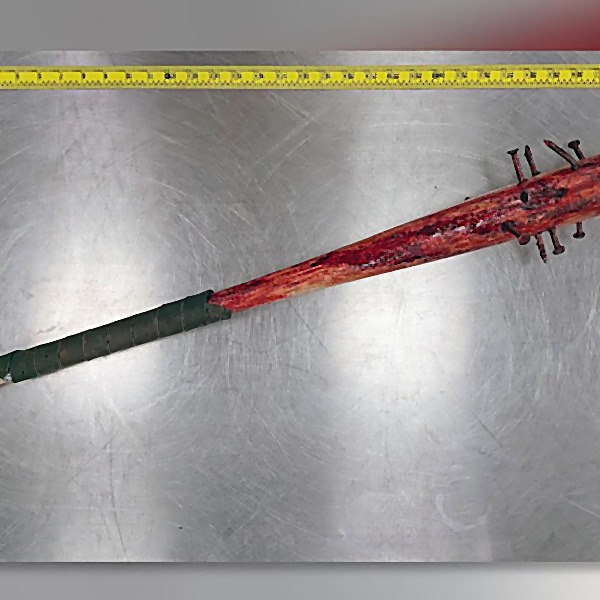 Wood baseball bat modified with spikes and a leather-wrapped hilt with smears of a reddish-brown substance