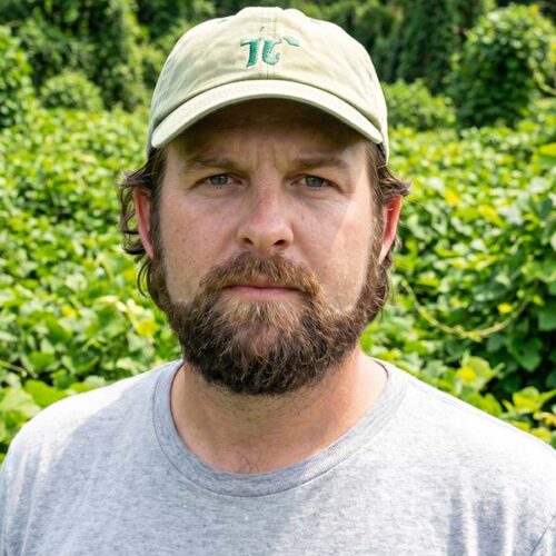 Man with dark hair and facial hair