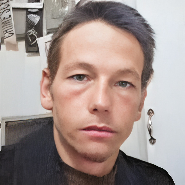 Unsmiling man with short dark hair