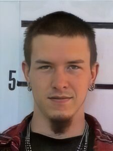 Young man with dark hair and goatee