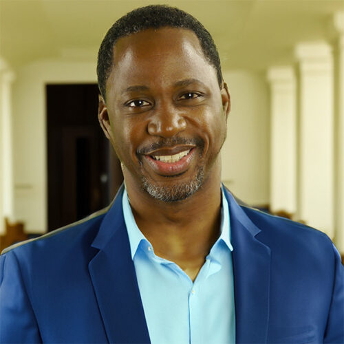 Smiling man with dark, close-cropped hair and graying goatee
