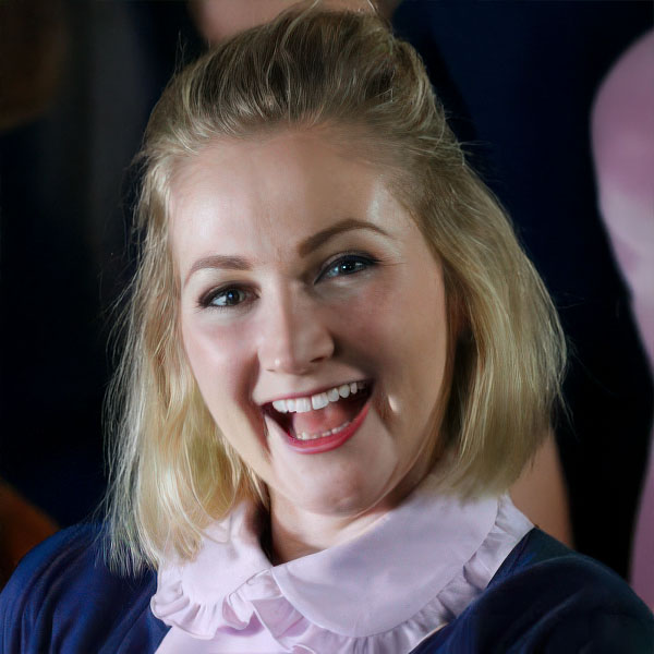 Broadly smiling woman with chin-length blonde hair